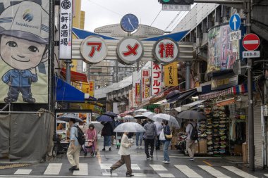 Tokyo, Japonya - 13 Mayıs 2024: Tokyo, Japonya 'daki Ameyoko market mahallesi. Ameyoko Alışveriş Sokağı yükseltilmiş demiryolu hattının altında bir mağaza koleksiyonudur..