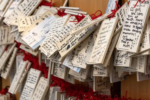 stock image Tokyo, Japan- 19 May 2024: Ema hang on the wall inside Haneda Airport, Tokyo. Ema are small wooden plaques which worshippers write their prayers