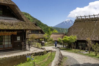 Kawaguchiko, Japan- 16 May, 2024: Saiko Iyashi no Sato Nenba or Traditional Japanese Village in Kawaguchiko, Japan. This is a beautiful place to assemble ancient farm houses close to Mount Fuji clipart