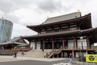 Tokyo, Japan- 12 May 2024: Tourists visit to Zojoji in Tokyo. Zojoji  was founded in 1393 as an orthodox and fundamental nembutsu seminary for Jodo shu in the Kanto clipart