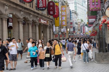Guangzhou, Çin - 9 Haziran 2024: Çin 'in Guangzhou kentindeki ShangXiaJiu Pedestrian Caddesi' nde insanlar alışveriş yapıyor. Bu cadde yaklaşık 800 metre uzunluğunda ve her iki tarafında 250 dükkan var.