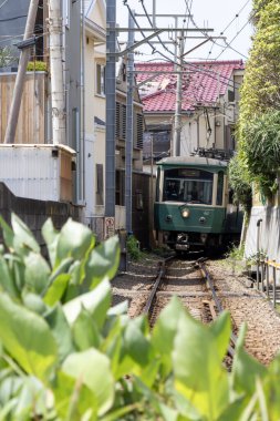 Kamakura, Japan- 14 May, 2024: View of retro Enoden train in Kamakura, Japan. Enoshima Electric Railway offers a unique retro and scenic train ride from Kamakura to Fujisawa clipart