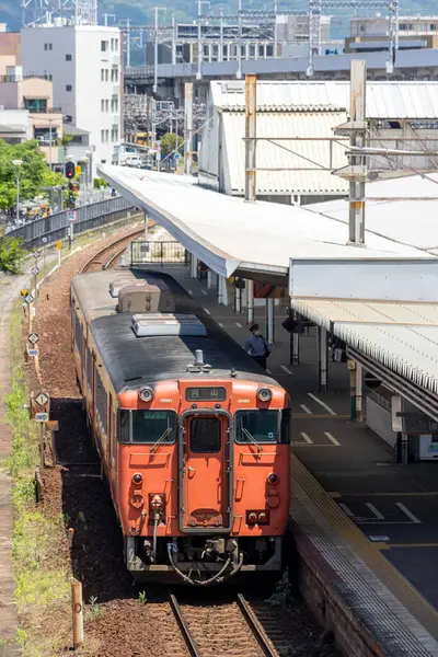 Stock image Okayama, Japan- 9 May, 2024: Passengers alight from a local train arrived at Okayama train station.