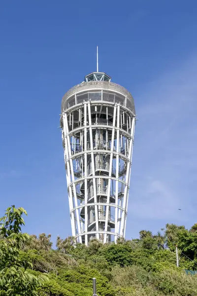 stock image Enoshima, Japan- 14 May, 2024: View of the Enoshima sea candle with blue sky in Enoshimo island, Japan. It is an observation tower and lighthouse