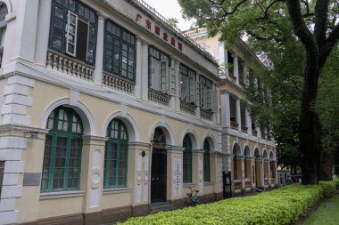 Guangzhou, China- 6 Jun 2024: Old European style building at the corner of a street in Shamian island. This tiny island is used to be a prosperous foreign enclave, it owns many exotic buildings. clipart