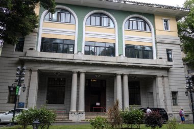 Guangzhou, China- 6 Jun 2024: Old European style building at the corner of a street in Shamian island. This tiny island is used to be a prosperous foreign enclave, it owns many exotic buildings. clipart