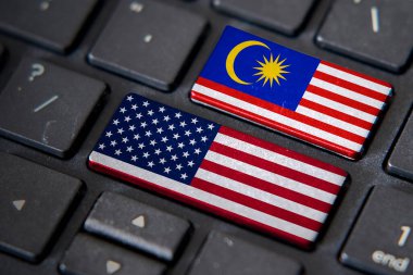 USA and Malaysia flags on computer keyboard. Relationship between two countries. clipart