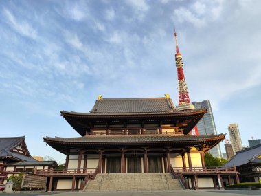 Tokyo, Japan- 11 May, 2024: Ancient Zojoji temple and Tokyo tower in blue sky. clipart