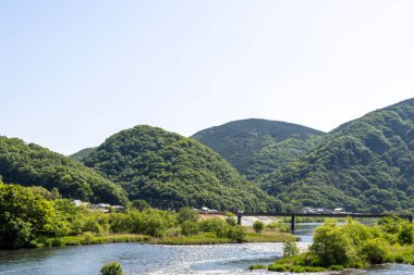 Beautiful green scenery of Asahi River in Okayama, Japan. clipart