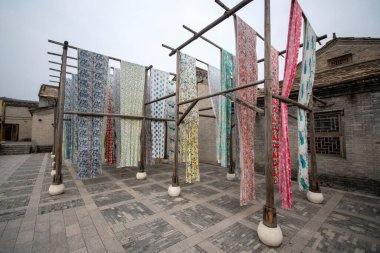 Beijing, China-11 Nov 2024: Yongshun Dye House located in Gubei Water Town, Beijing. This is a good spot to take pictures with the different colors of the cloths hanging around clipart