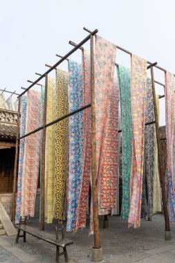 Yongshun Dye House located in Gubei Water Town, Beijing. This is a good spot to take pictures with the different colors of the cloths hanging around clipart