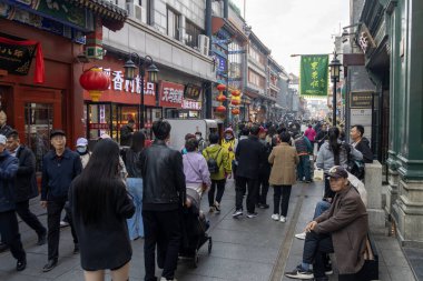 Beijing, China- 11 Nov 2024: View of Dashilan pedestrian street in Beijing. It is a historic Beijing street blending traditional culture with modern shopping, dining, and architecture. clipart