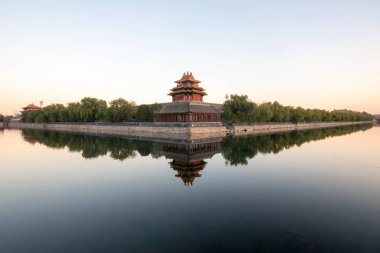 Beautiful water reflection of Forbidden City Corner Tower or Jiaolou in Beijing, China. Corner Towers stand in the 4 corners of the Forbidden City, each with 3-layer of complex roof. clipart