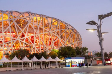 Beijing, China- 6 Nov 2024: View of Beijing National Stadium, also known as the Bird Nest, at dusk in Beijing, China. It officially started construction in March 2004, and was completed in June 2008 clipart