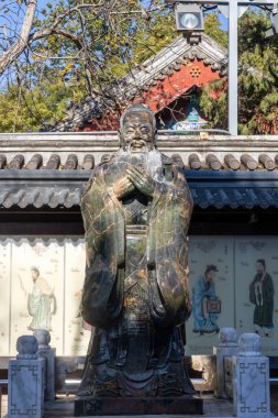 Beijing, China- 5 Nov 2024: Statue of Confucius in Guozijian - Imperial Academy in Beijing. Guozijian is the only imperial college from ancient times preserved up to now clipart