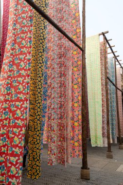 Yongshun Dye House located in Gubei Water Town, Beijing. This is a good spot to take pictures with the different colors of the cloths hanging around clipart