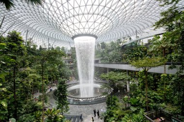Singapur - 8 Nisan 2025: Dünyanın en uzun kapalı şelalesi, Yağmur Girdabı, Changi Jewel, Singapur 'da bir teras ormanı ile çevrili..
