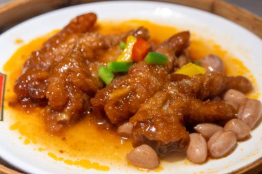 Bambu buharlı bir buharlı tencerede servis edilen kavurmalı tavuk budu.