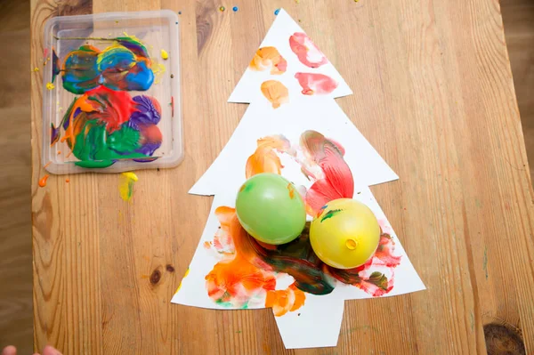 Painting Christmas tree. Occupational therapy, ergo therapy, calming activities. Painting with balloons. Hand stimulation, freedom of creativity. Montessori method for kindergarten and preschool.