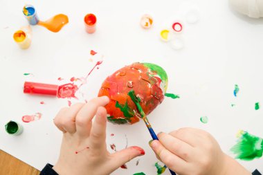 Easter egg made of plaster. Montessori implement to stimulate creativity, to keep focus on the task, stress relief. Preschool activities at home.