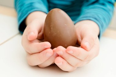 Celebrating Easter with a chocolate egg. Happy family vacation. Celebrating Easter. Happy family vacation.