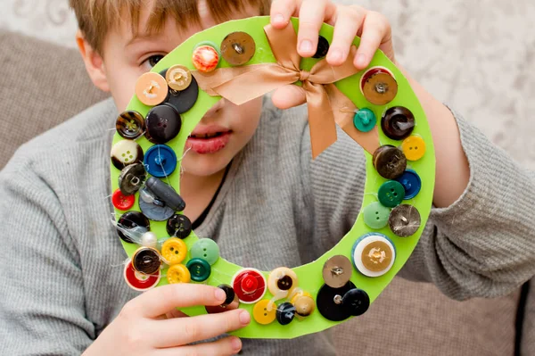 古いボタンと紙から子供によって作られたアドベント花輪 — ストック写真