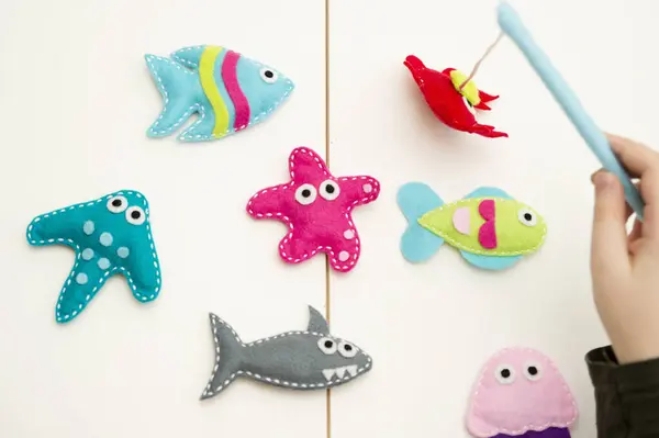 Hand made stuffed felt toy. Fishing rod with magnet and fishes or other sea animals. Different colors. Safe eco stuffed toy for infants and toddlers. Early education implement.