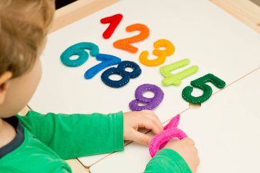 Hand made stuffed felt numbers from 1 to 10 in different colors. Safe eco stuffed toy for infants and toddlers. Early education. Learning colors and to count from zero to ten. Early education.