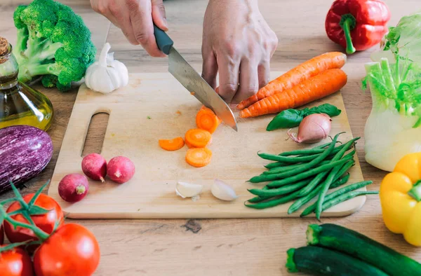 stock image Hands cutting vegetables in the kitchen