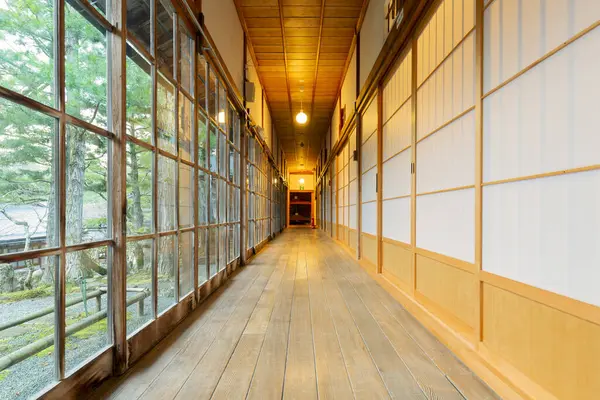 Traditional japanese house corridor with tatami floor and shoji paper doors.