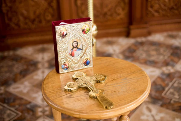 old wooden christian cross and icon in church