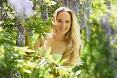 Bahar parkında çiçekli bir kadın.