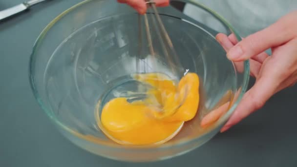 Жіночі Руки Перемішують Яєчні Жовтки Скляній Мисці Кухонним Віночком Крупним — стокове відео