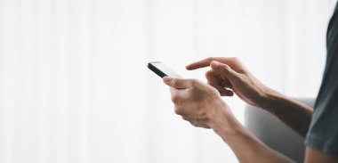 Closeup of man using a smartphone, searching, browsing, social media, message, email, play game, internet digital marketing, online shopping.