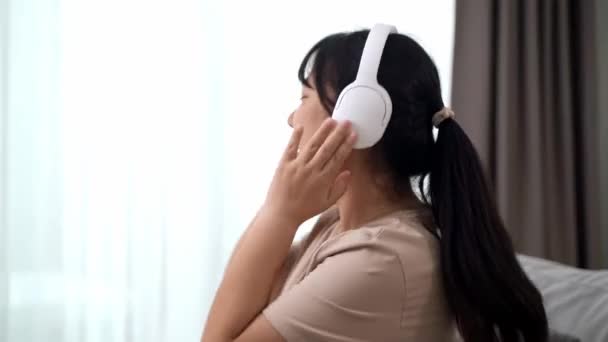 Mujer Joven Escuchando Música Con Auriculares Relajándose Mientras Está Sentada — Vídeos de Stock