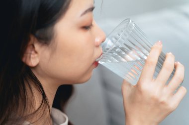 close up shot of a woman drinking water from a glass. Healthy, food and drink concept.