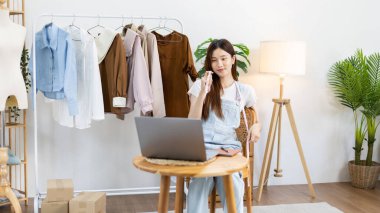 Professional female designer sketches of clothes through laptop in the design studio, Fashion designer, Creativity and ideas, Mannequin, Shirt sketch, Color scheme, Garment accessories ,Freelance.