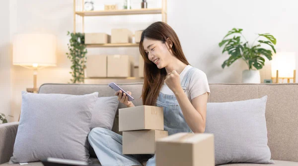 Woman was happy after receiving an order from an online customer, New business style for  people working at home and owning businesses, Online shopping SME entrepreneur, Packing box, Sell online.