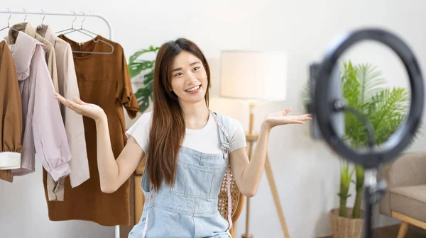 stock image Beautiful woman with a social media influence is greeting the audience for recording vlog video live streaming, Online fashion clothing business, Using psychology to generate interest in customers.