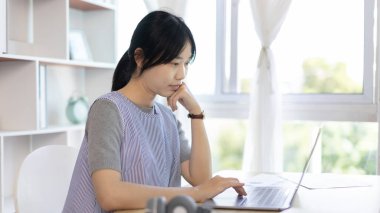 Genç Asyalı kadın, arkadaşları ve öğretmenlerini yüzünde gülümseme, internet iletişimi, evde kalmak, yeni normal, VDO çağrısı, sosyal mesafe, internet öğrenimi ile canlı bir videoda selamlıyor..