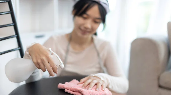 Housewives use towels to wipe things, tables, chairs, display cabinets and glass inside the house,, Big cleaning, Housework, Daily routine ,Removes germs and dirt and deep stains, Spray alcohol, Clean up on weekends