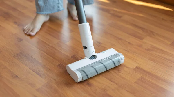 Woman vacuuming the floor of her living room, Big cleaning in the house, Removes germs and dirt and deep stains, Housewife cleaning, Keeping her home clean, Domestic hygiene.