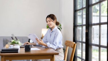 Work from home, College student is analyzing data or doing homework assignments in her house, Use your laptop to search for information and educate yourself at home, Stay home, Internet learning.