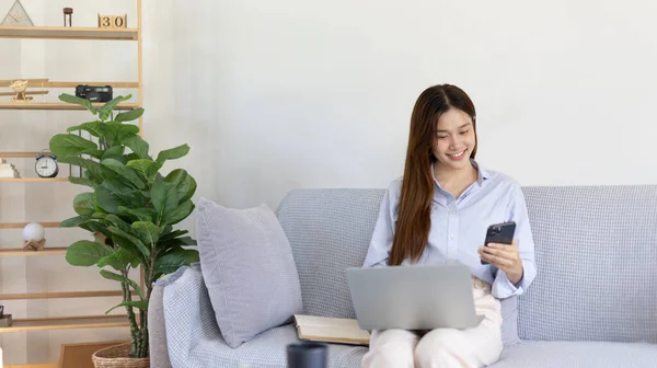 Woman working at home, Attractive woman chatting or talking with colleague on mobile phone at her home, Work for home, Remote conversation or meeting , Stay home, Use a cell phone or smartphone.