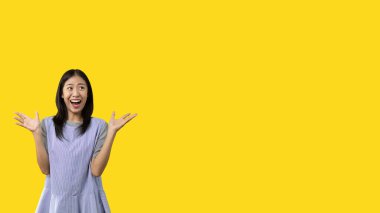 Asian woman acting shocked or surprised isolated on a white background,  Looking camera, Concept acts according to the emotions and feelings of excitement and shock, Yellow background, Copy space.