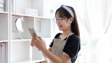 Housewives use towels to wipe things, tables, chairs, display cabinets and glass inside the house, Big cleaning, Housework, Daily routine ,Removes germs and dirt and deep stains, Spray alcohol, Clean up on weekends