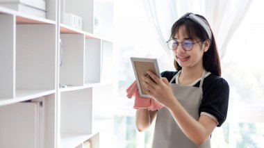 Housewives use towels to wipe things, tables, chairs, display cabinets and glass inside the house, Big cleaning, Housework, Daily routine ,Removes germs and dirt and deep stains, Spray alcohol, Clean up on weekends