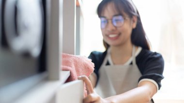 Housewives use towels to wipe things, tables, chairs, display cabinets and glass inside the house, Big cleaning, Housework, Daily routine ,Removes germs and dirt and deep stains, Spray alcohol, Clean up on weekends