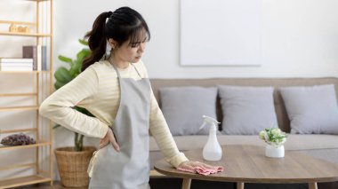 Housewife with back pain and shoulder pain from doing hard housework on weekends, Big cleaning, Housework, Daily routine , Cleaning spray and rags, Spray alcohol, Clean up.