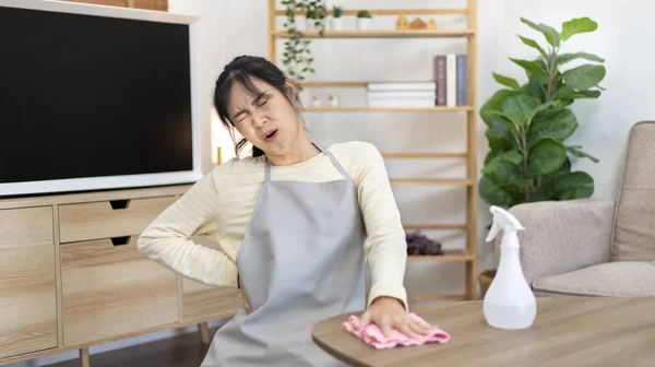 Housewife with back pain and shoulder pain from doing hard housework on weekends, Big cleaning, Housework, Daily routine , Cleaning spray and rags, Spray alcohol, Clean up.